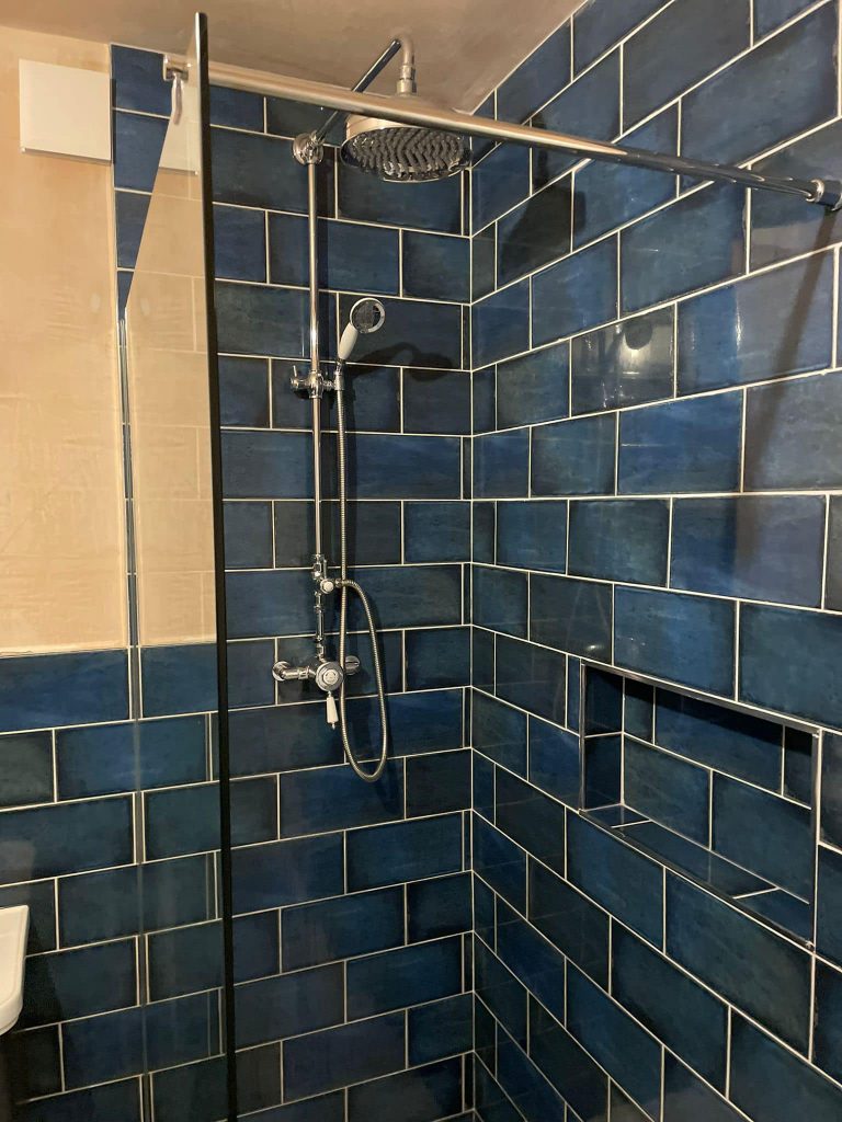 Modern blue bathroom design Guiseley with patterned tiles