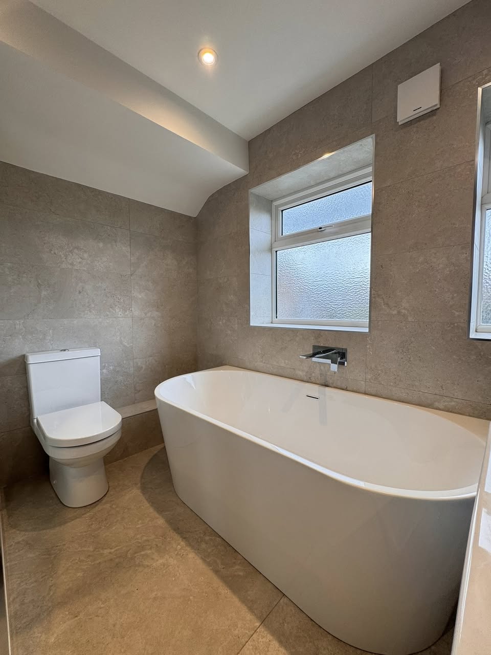 Green tiled bathroom with floor standing bath, Otley