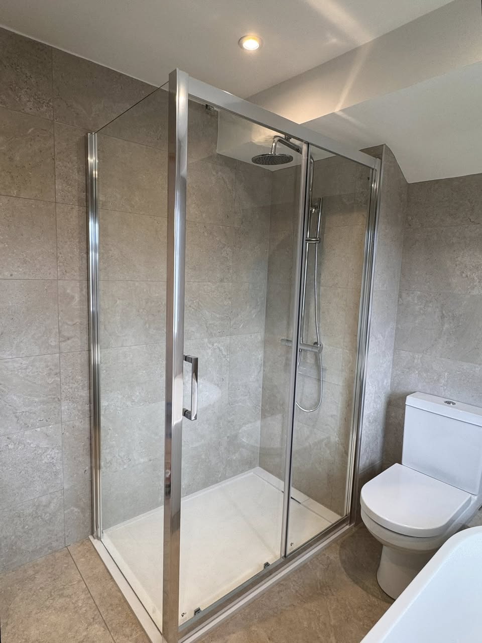 Green tiled bathroom with floor standing bath, Otley