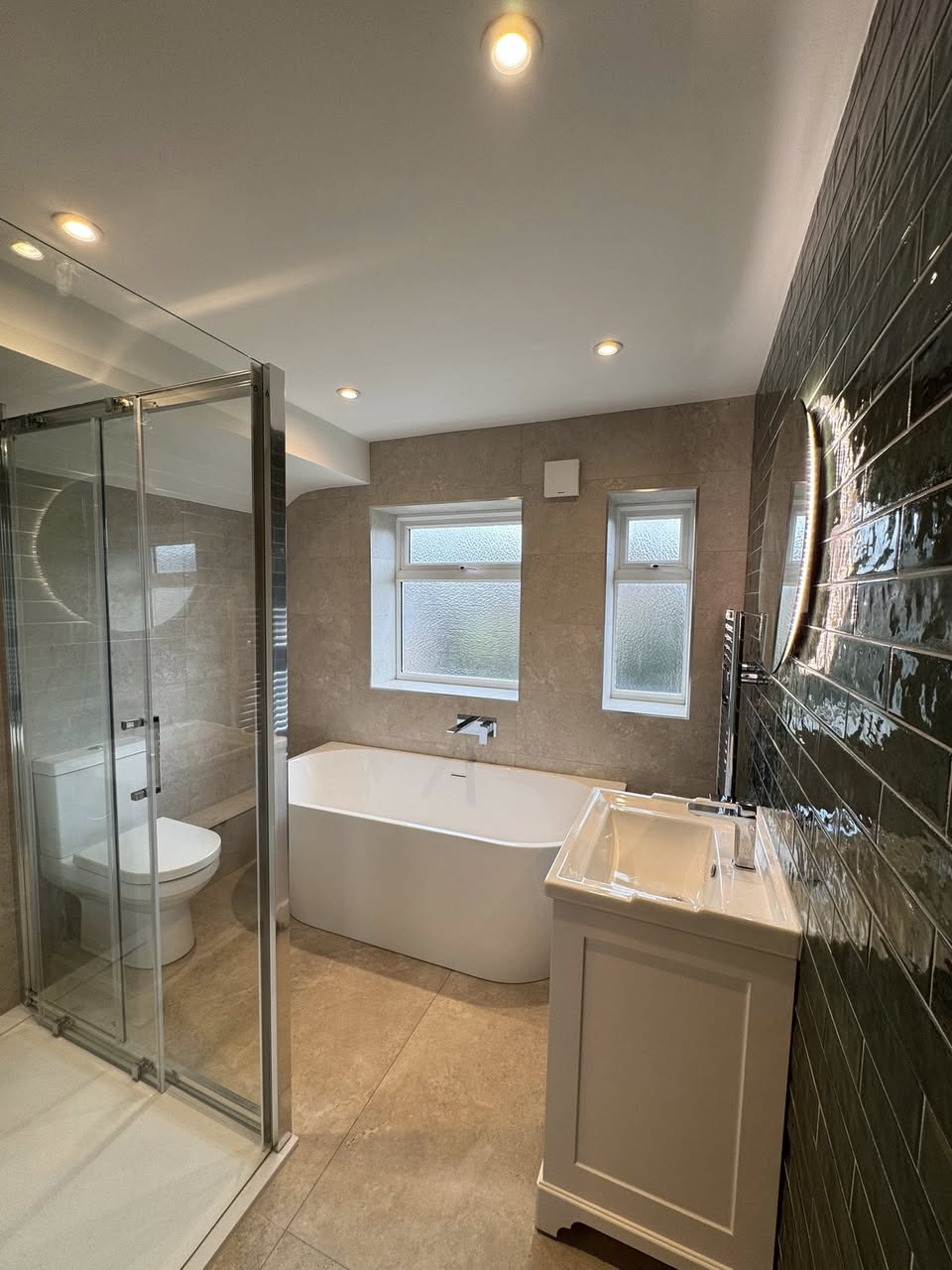 Green tiled bathroom with floor standing bath, Otley