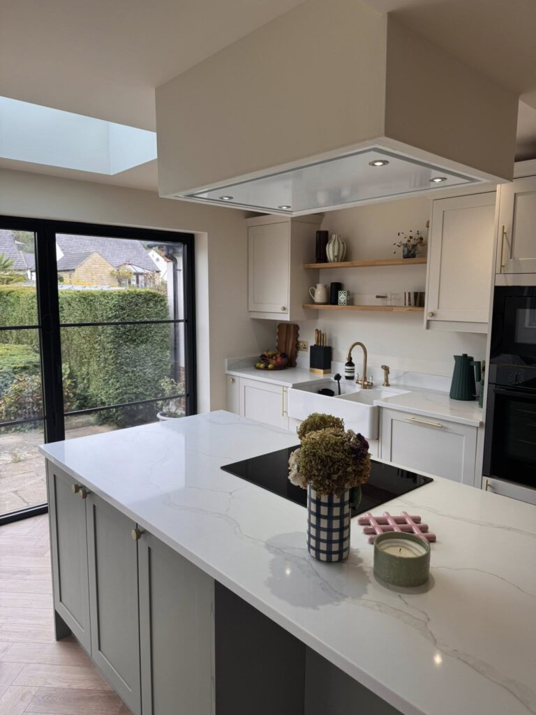 SR Kitchen renovation and installation of Kitchen Otley with cream kitchen units and granite worktop, gold kitchen handles and tap with kitchen island and underfloor heating. A stunning kitchen transformation in Otley