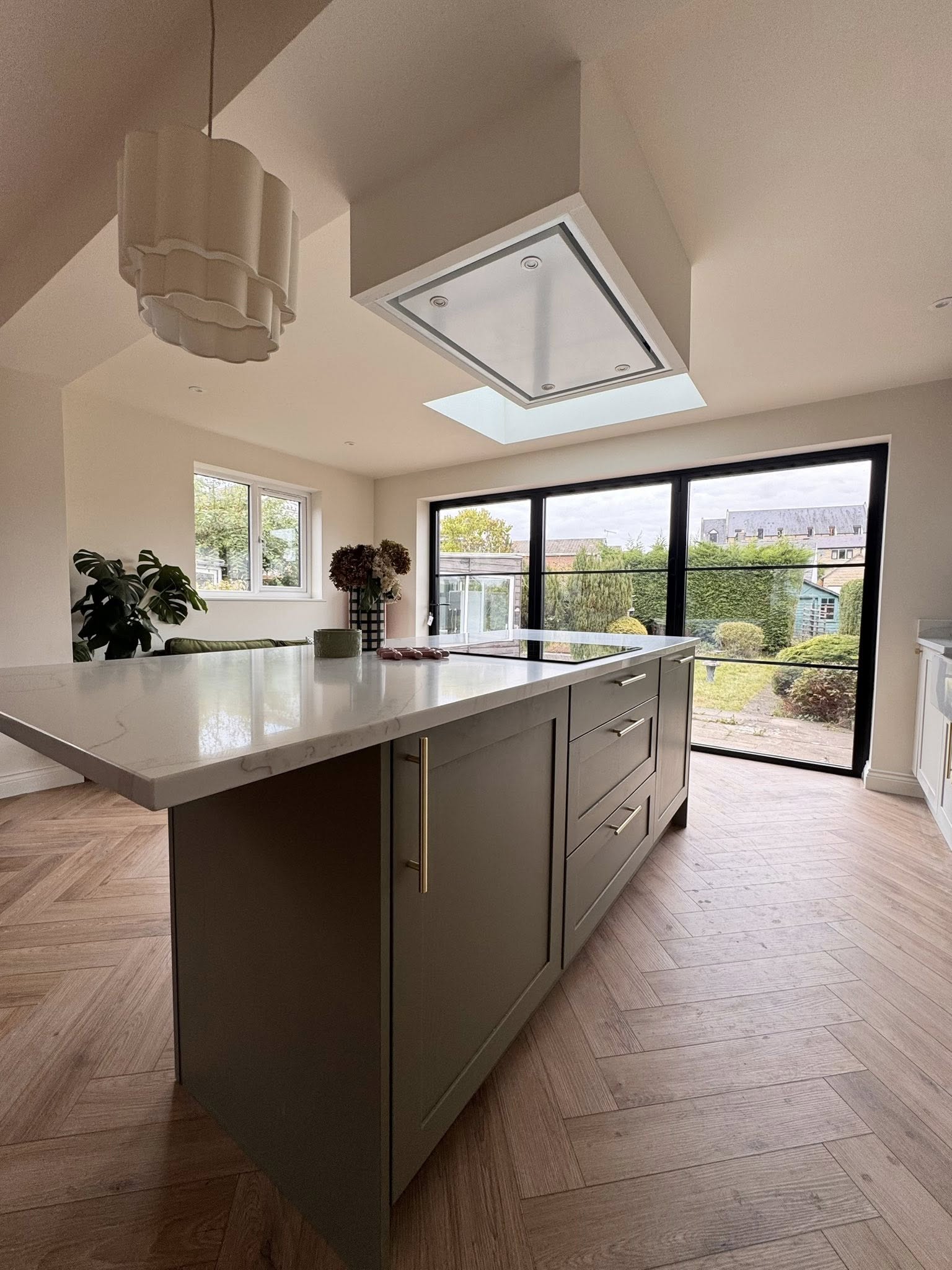 SR Kitchen renovation and installation of Kitchen Otley with cream kitchen units and granite worktop, gold kitchen handles and tap with kitchen island and underfloor heating. A stunning kitchen transformation in Otley