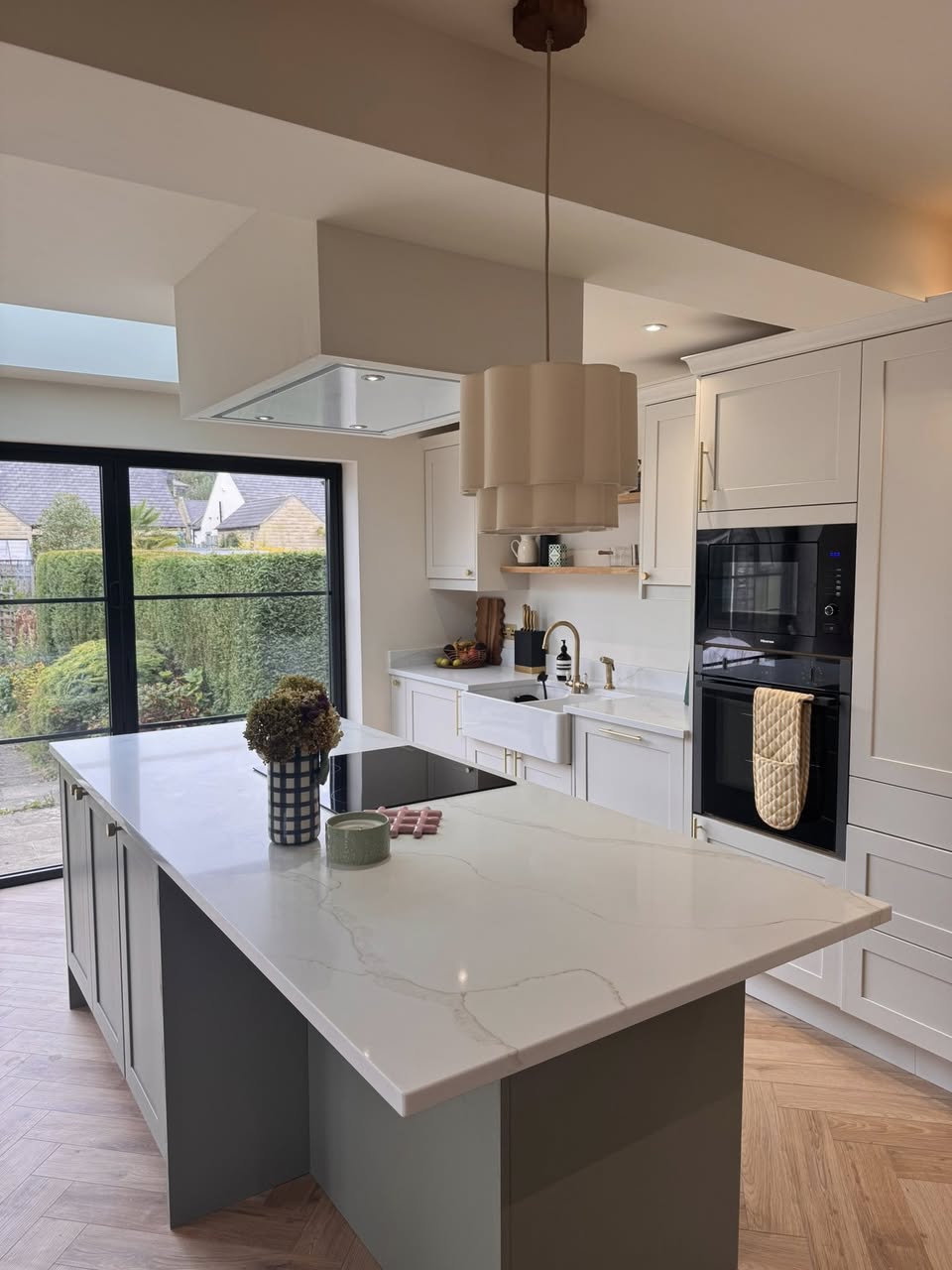 SR Kitchen renovation and installation of Kitchen Otley with cream kitchen units and granite worktop, gold kitchen handles and tap with kitchen island and underfloor heating. A stunning kitchen transformation in Otley