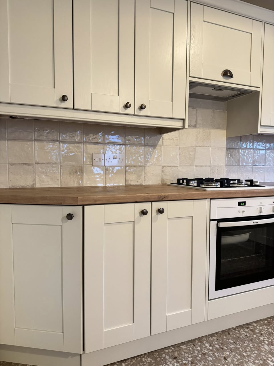 SR Kitchen and bathroom kitchen design and installation Otley with tiled floor, cream kitchen units and wooden worktop