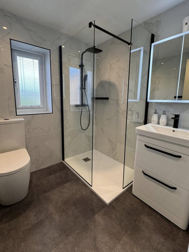 white marble shower room with black taps Otley