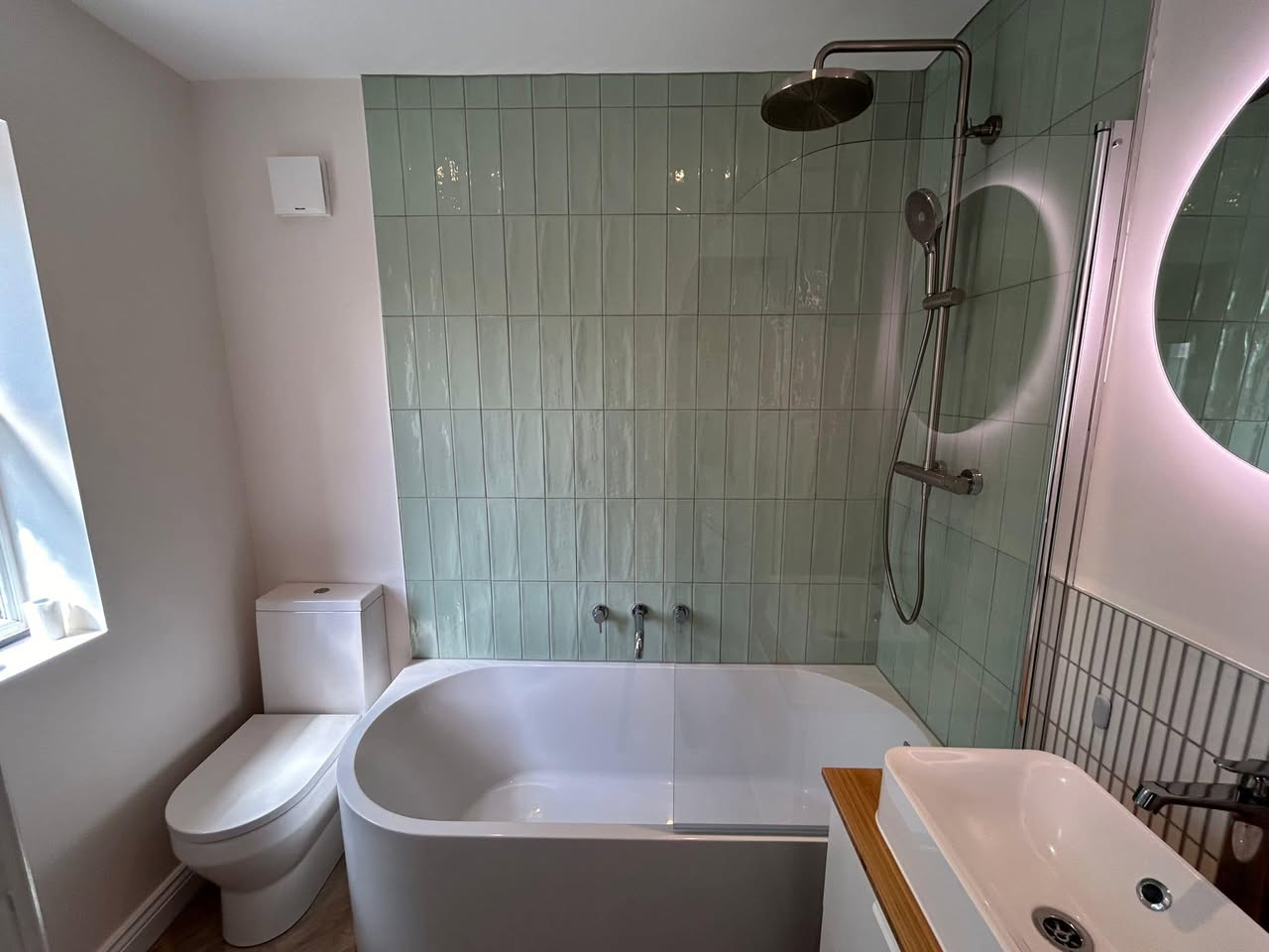 sage green bathroom with floating sink unit