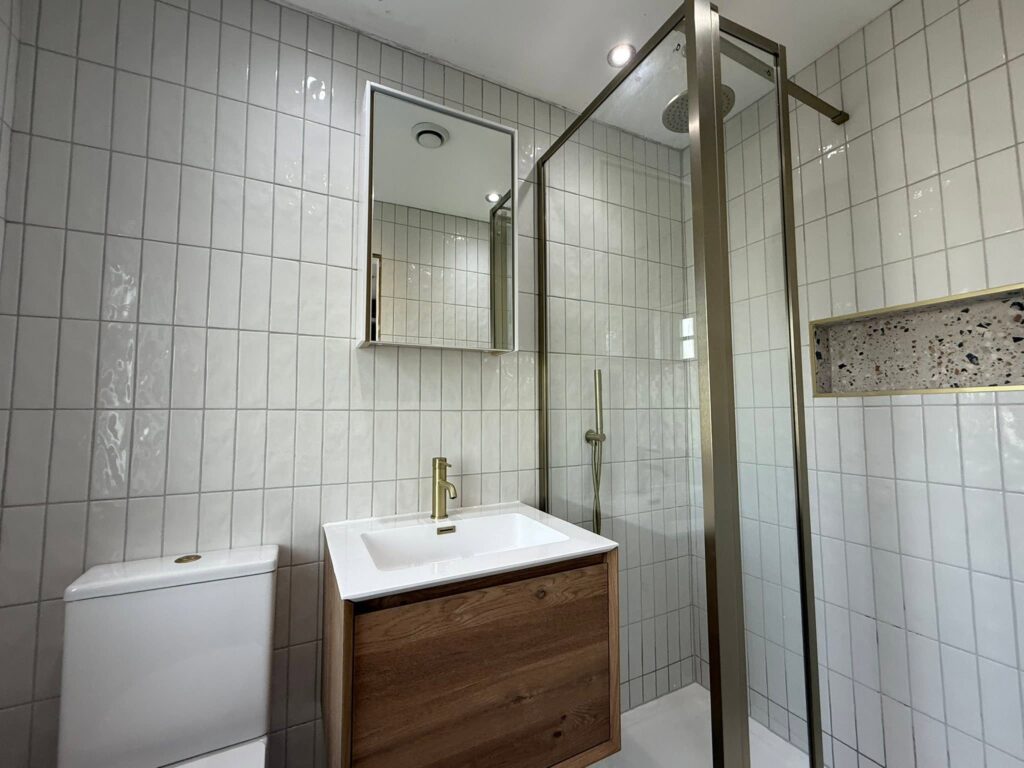 white modern bathroom shower room with gold fixtures Otley