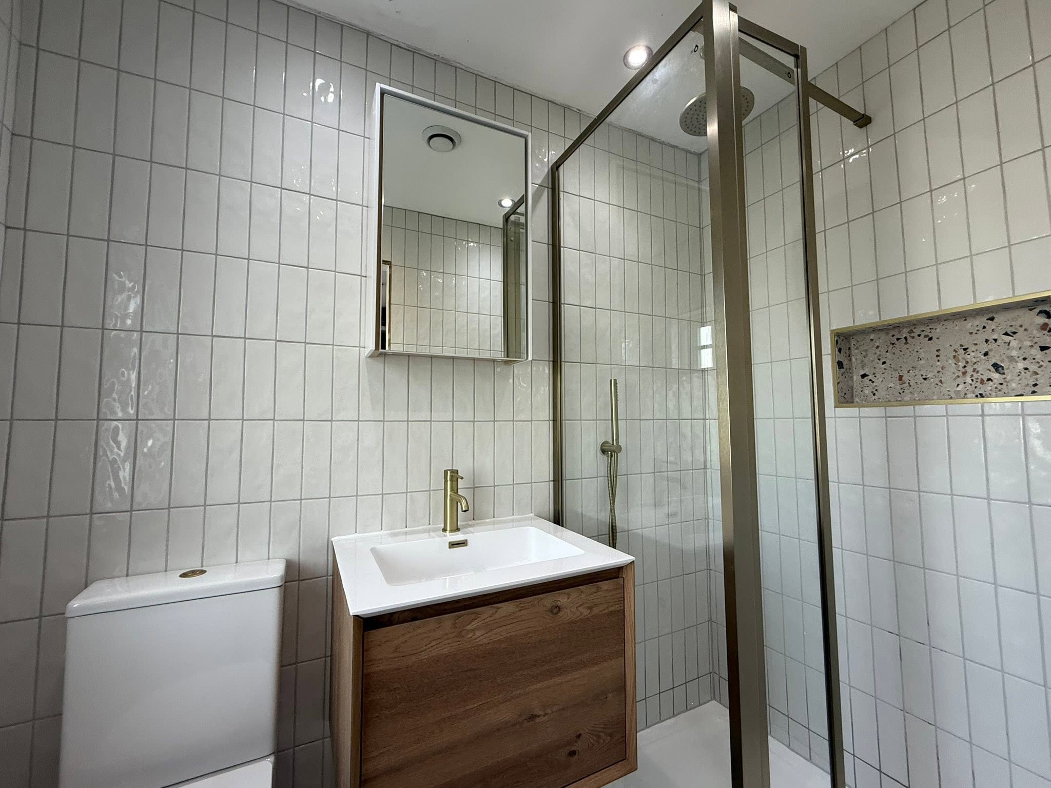 white modern bathroom shower room with gold fixtures Otley