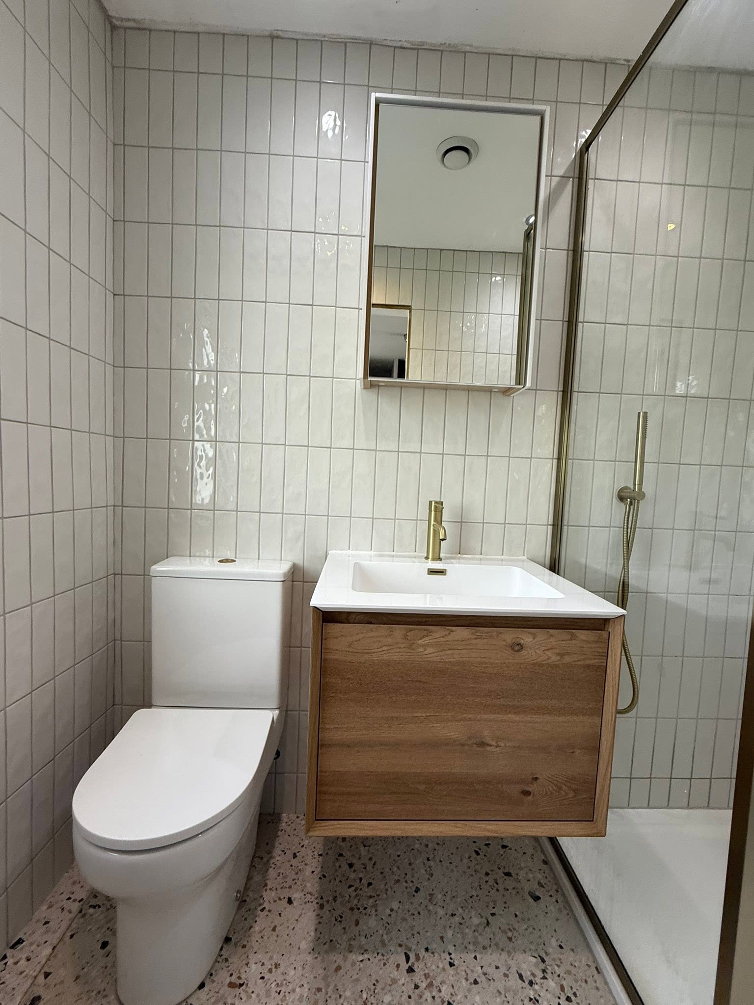 white modern bathroom shower room with gold fixtures Otley